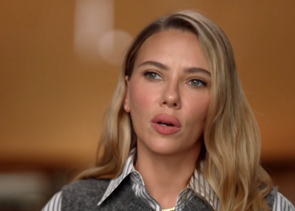 A idiosyncratic   with agelong  hairsbreadth  wearing a striped garment  and vest is speaking during an interview