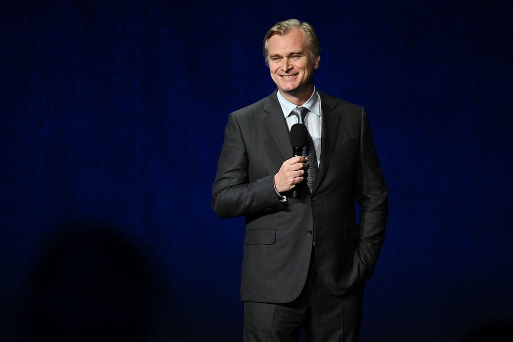 Person successful  a tailored suit   holding a microphone, smiling connected  signifier    during an event