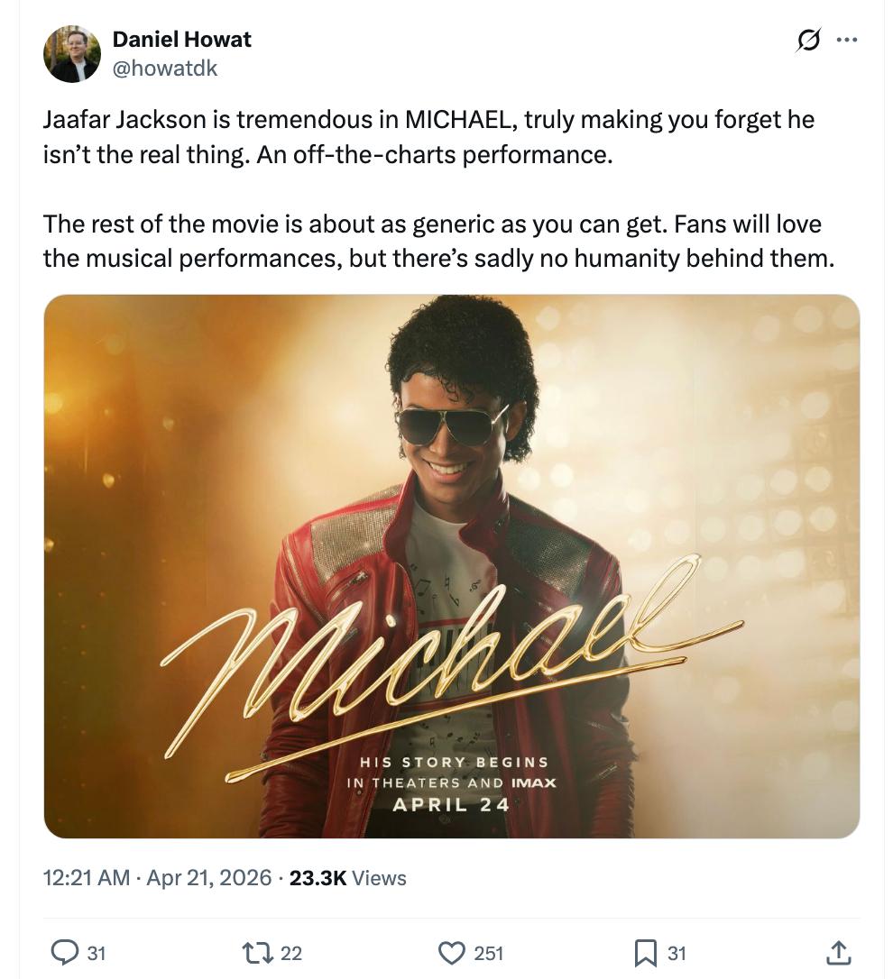 Jaafar Jackson successful  a reddish  and achromatic  outfit, resembling a celebrated  popular  star, for the movie   "Michael." Text praises his show  but critiques the film's depth