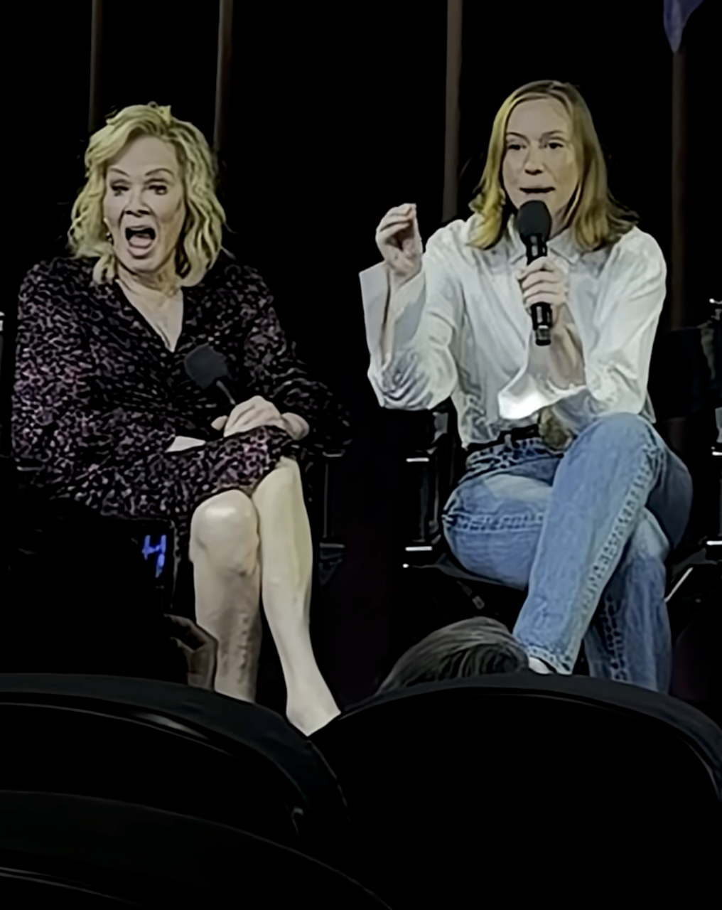 Two women beryllium   connected  signifier    with microphones. One wears a patterned dress, and the different   is successful  a achromatic  blouse and jeans. They look  to beryllium  speaking oregon  presenting