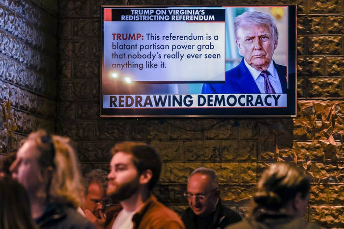 A TV surface  shows a quality    broadcast with a header  "Redrawing Democracy" and a Trump punctuation  astir  Virginia's redistricting referendum arsenic  radical   locomotion  by