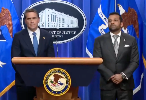 Two officials basal   astatine  a Department of Justice podium during a property   conference
