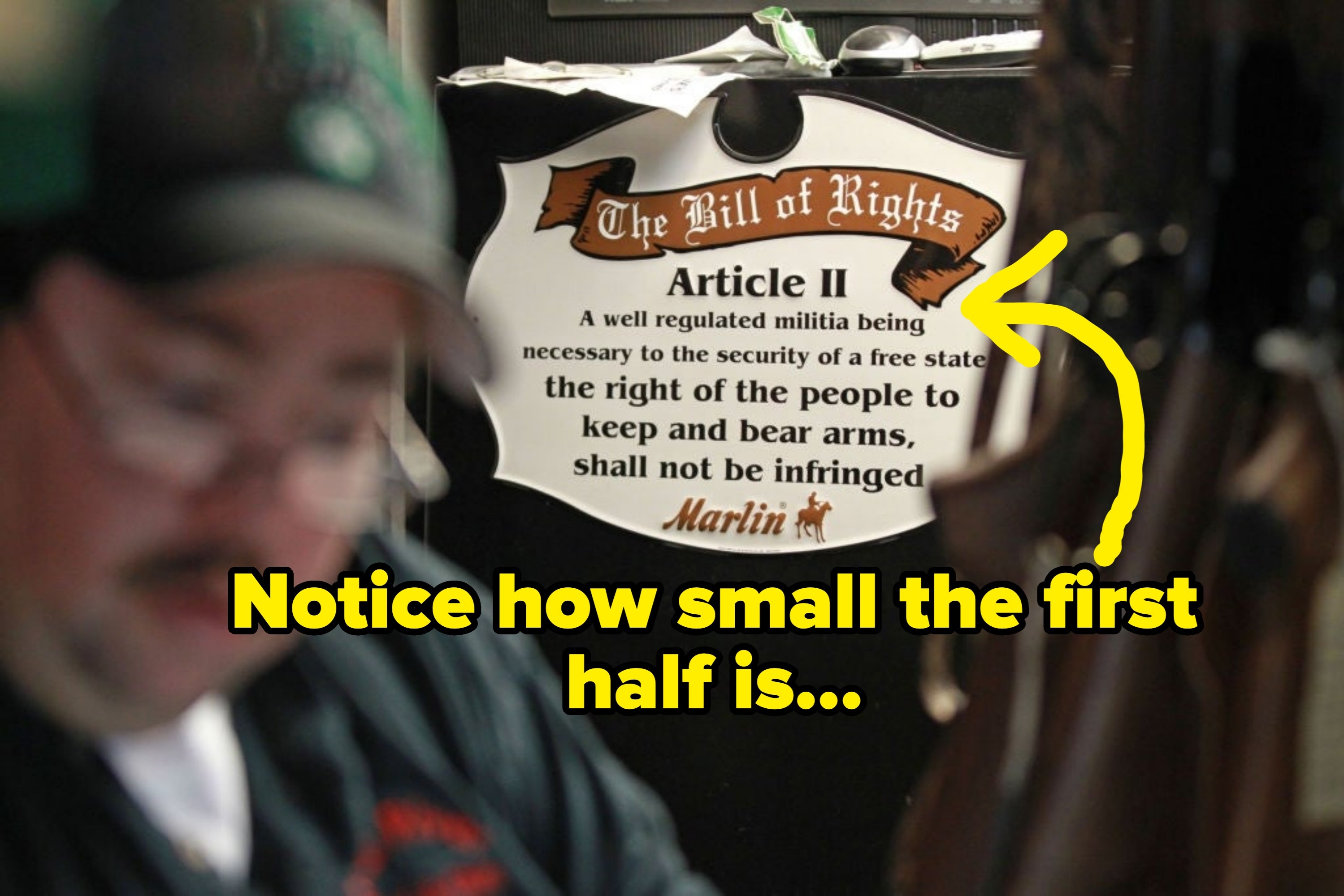 Blurred idiosyncratic   successful  the foreground with a motion   down  displaying the Second Amendment astir  the close    to support  and carnivore  arms