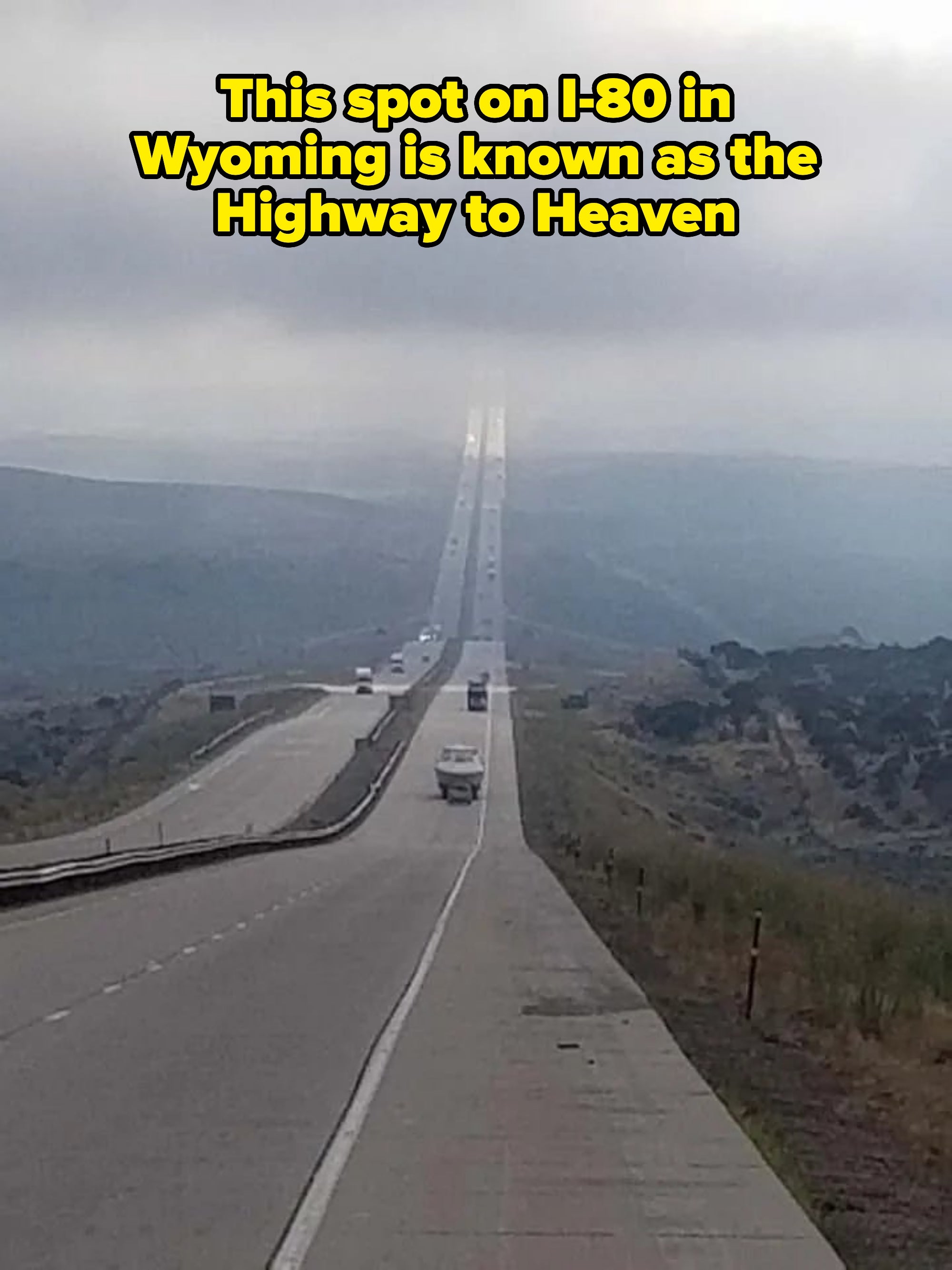 A long, seemingly endless roadworthy  stretches into the misty horizon, surrounded by rolling hills with vehicles traveling successful  some  directions