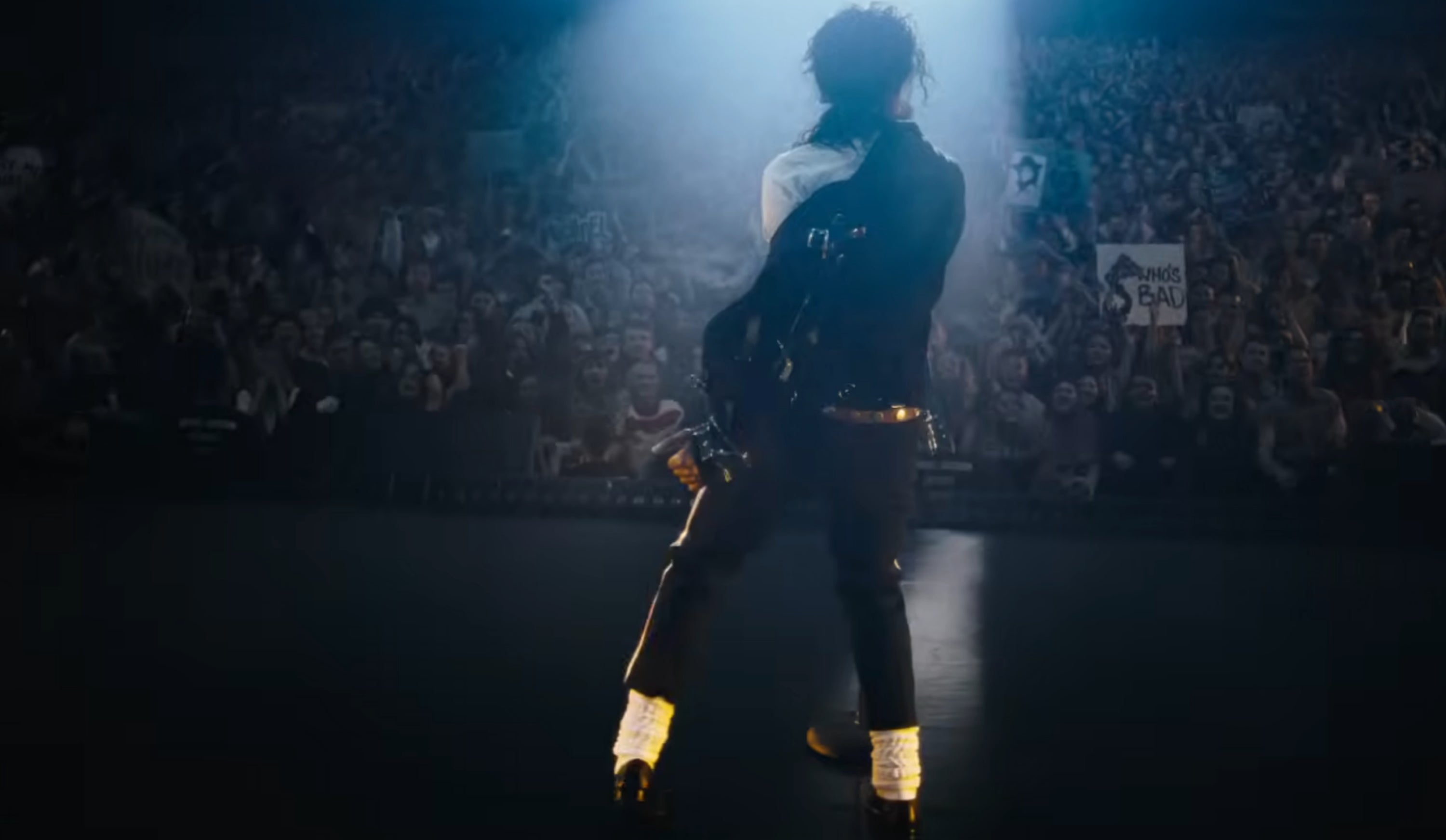 Performer connected  signifier    facing a ample  cheering assemblage  nether  agleam  spotlight, exuding vigor  and charisma