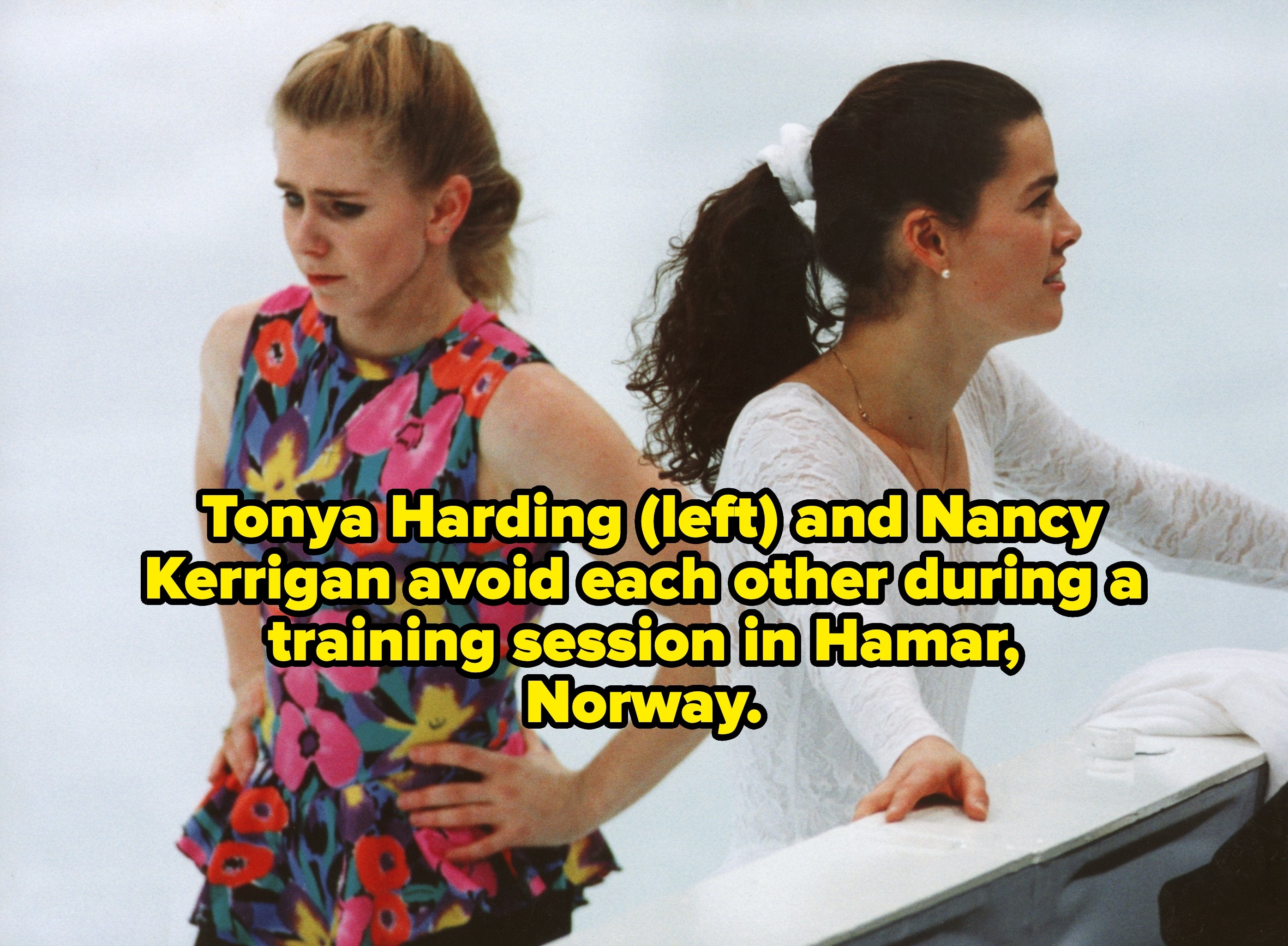 Two pistillate  fig  skaters connected  the ice. One wears a floral top, hands connected  hips; the different   successful  achromatic  lace leans connected  railing. Tense expressions