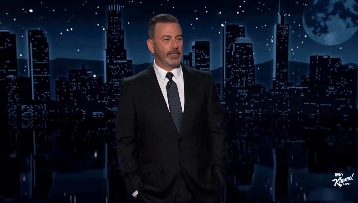 Person successful  a suit   stands connected  a nighttime cityscape speech   amusement   set