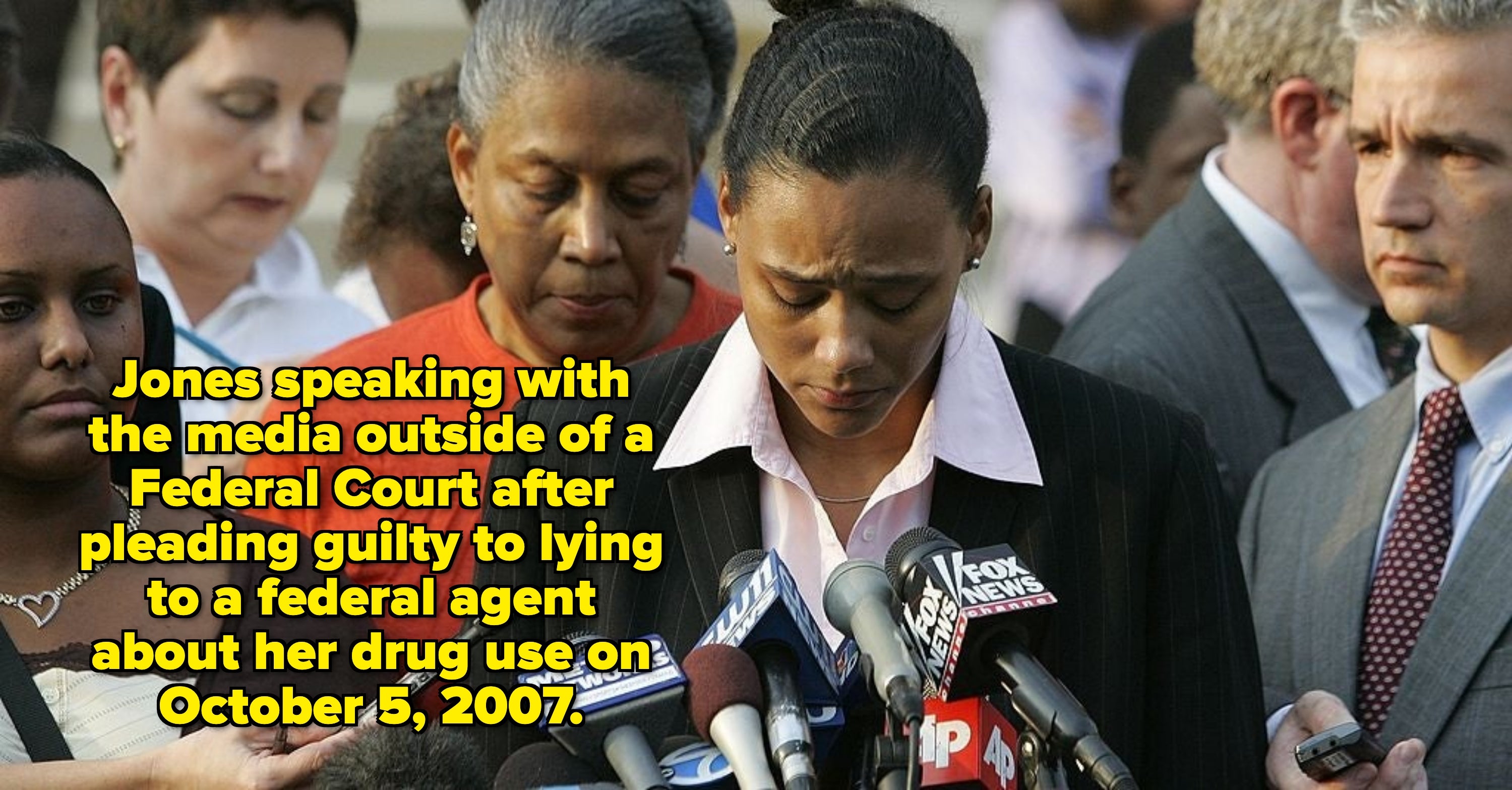 An jock  successful  a pinstripe suit   appears affectional  portion    speaking to media. Numerous microphones from assorted  quality    outlets are successful  beforehand   of them