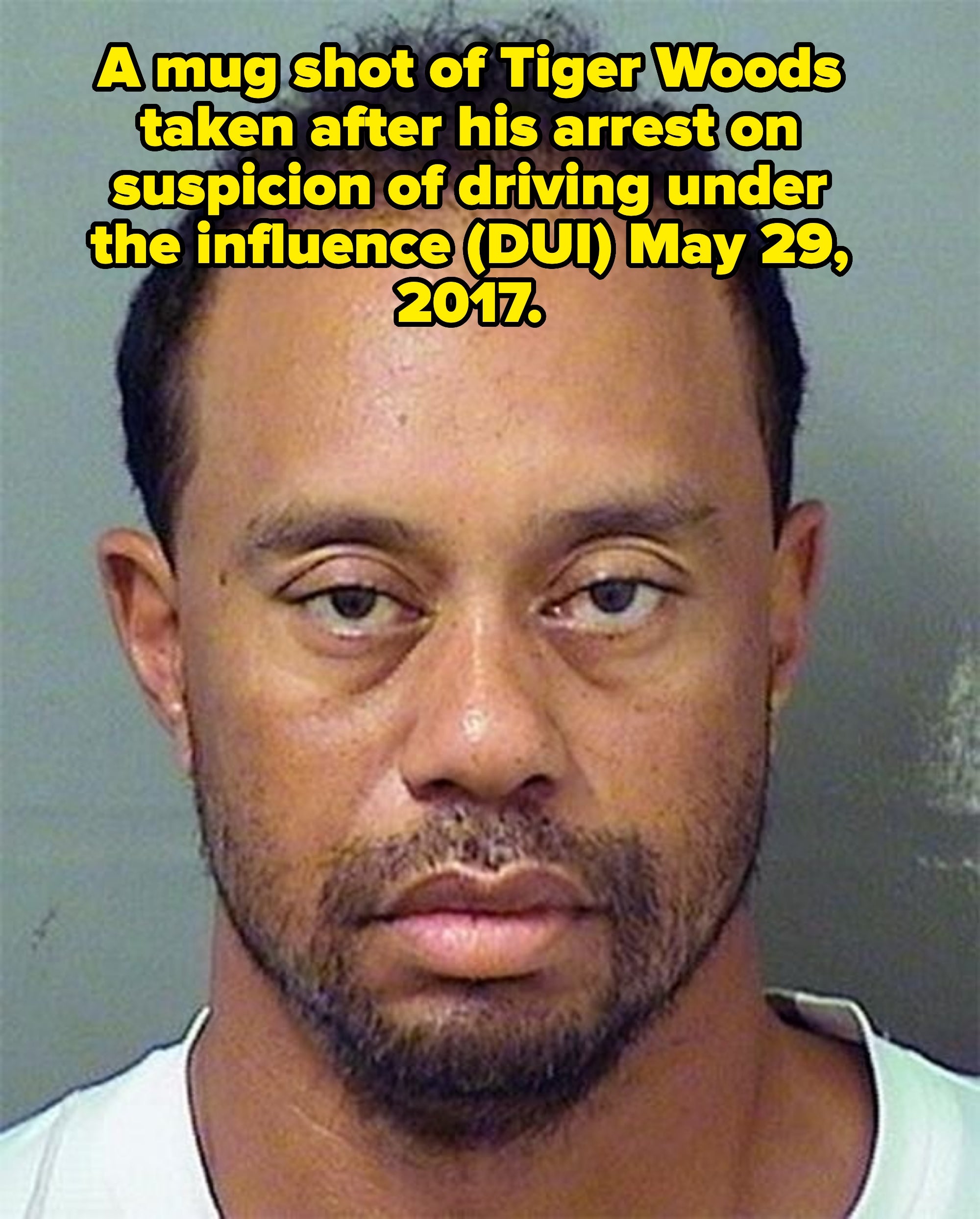 A idiosyncratic   with abbreviated  hairsbreadth  looks straight  astatine  the camera with a neutral look  against a plain background