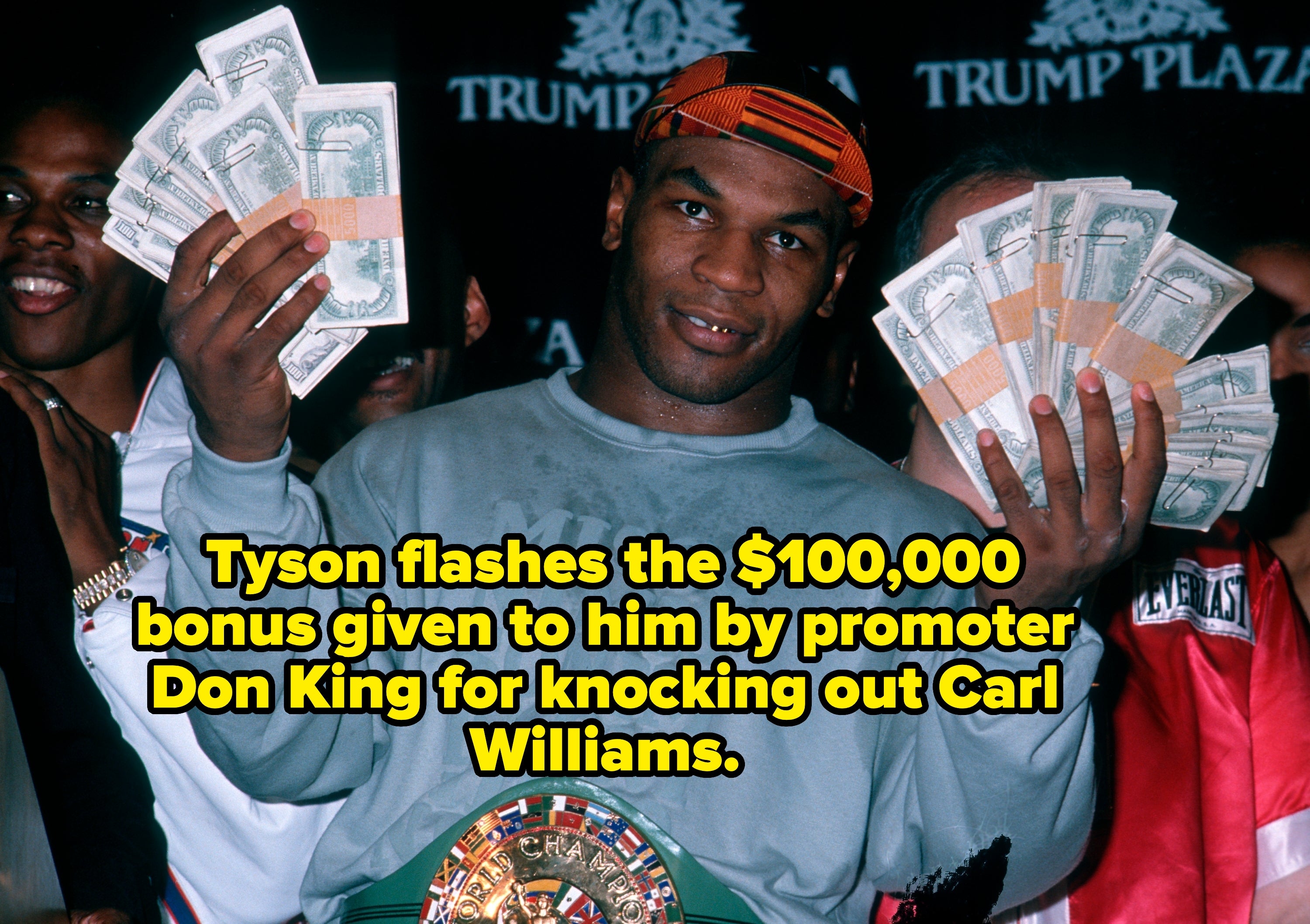 Boxer showing fists afloat  of cash, wearing a title  loop  and casual sweater, lasting  successful  beforehand   of a Trump Plaza backdrop