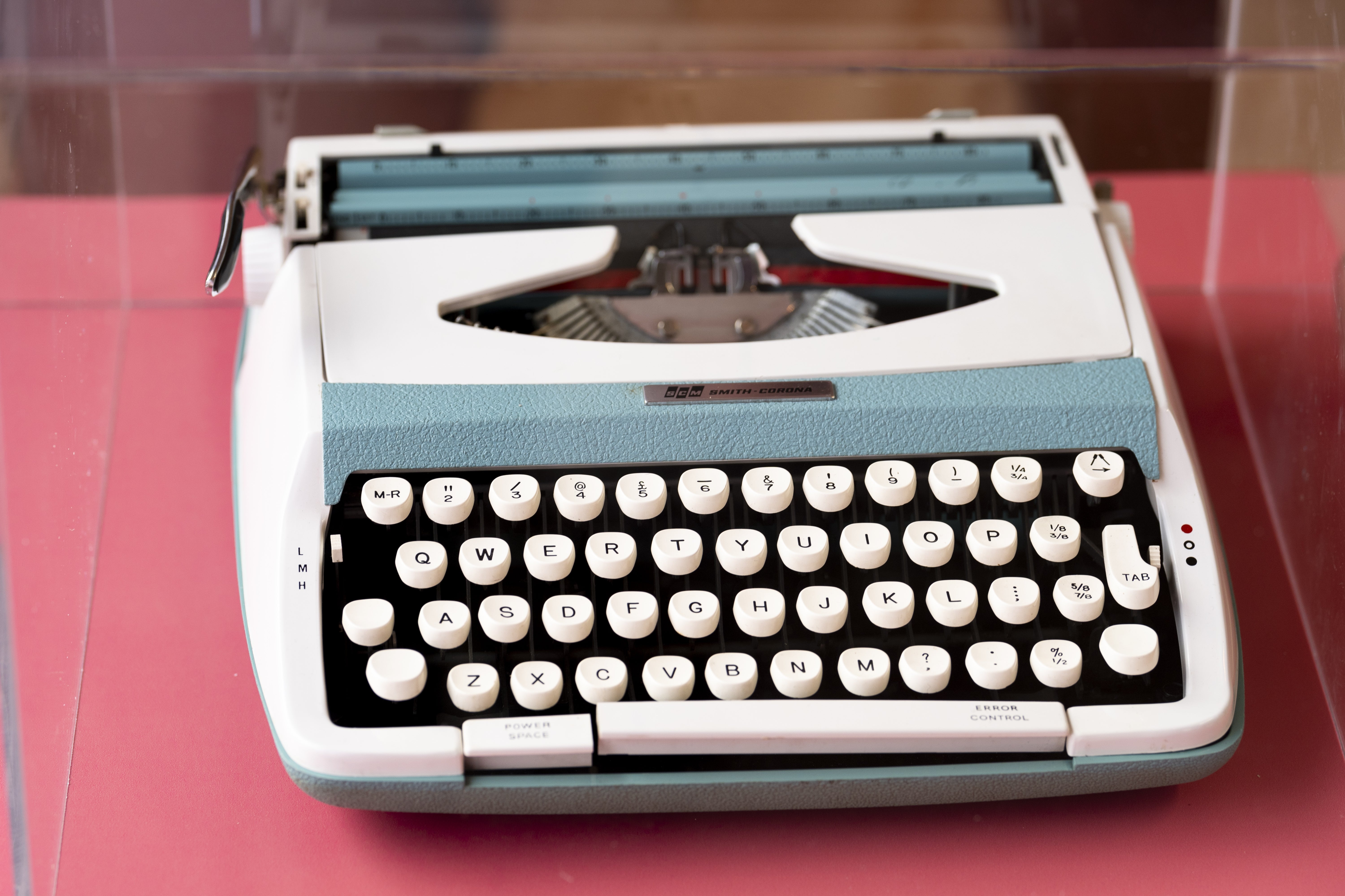 Vintage typewriter with achromatic  and achromatic  keys displayed successful  a protective case