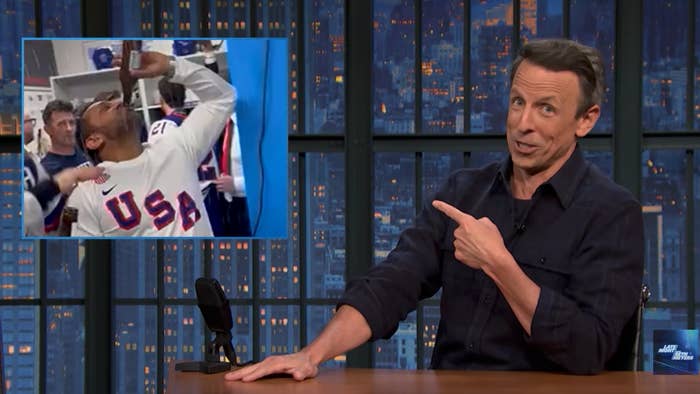 TV big   humorously points to an representation  on-screen of a idiosyncratic   jubilantly celebrating successful  a USA sports jersey