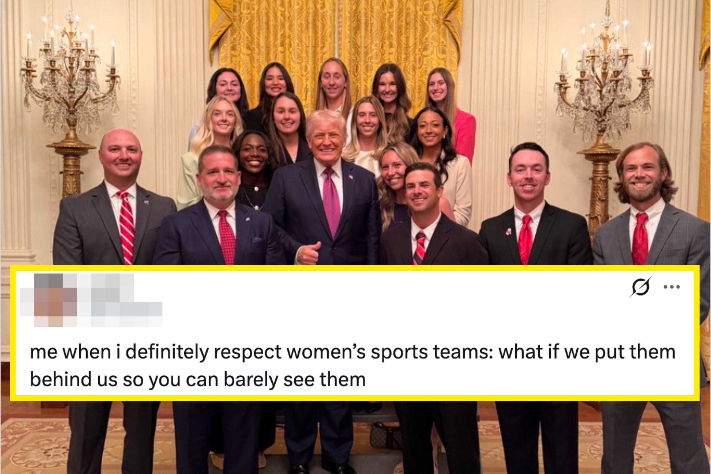 A group of people, including men in suits and women in formal attire, pose in an elegant room with chandeliers and gold drapes