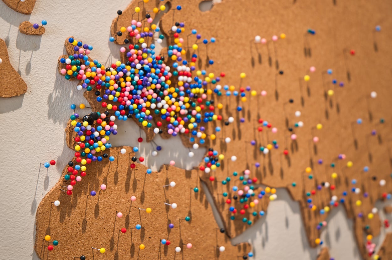 Corkboard map of Europe with colorful pins indicating various locations