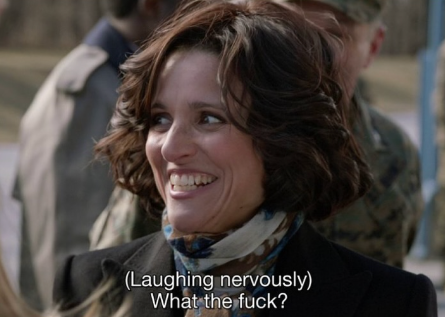 A pistillate   with abbreviated  hairsbreadth  and a scarf nervously laughs. Subtitles say, "(Laughing nervously) What the fuck?"