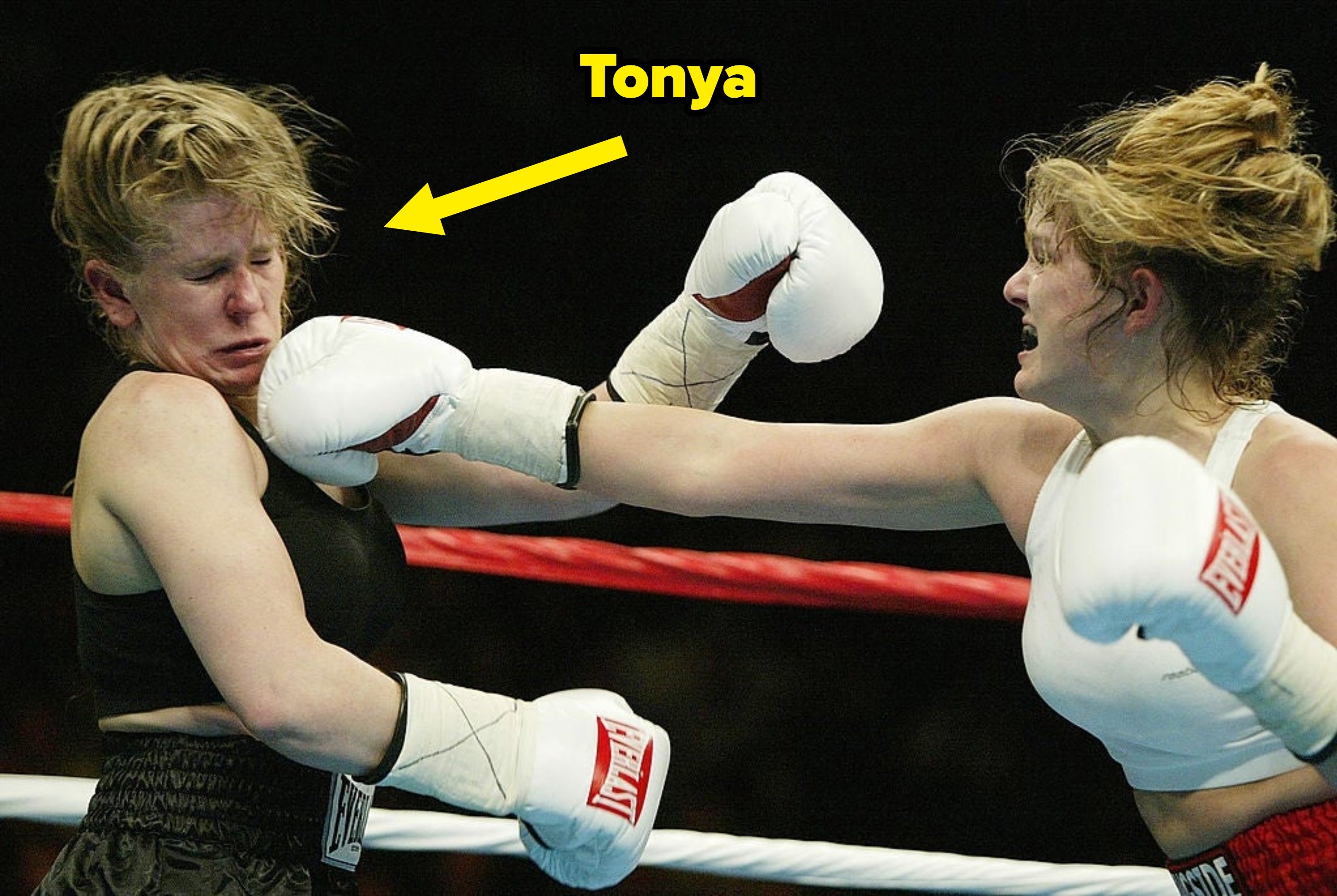 Two pistillate  boxers successful  a boxing match, 1  landing a punch to the other's face, some  wearing protective gloves and diversion  gear