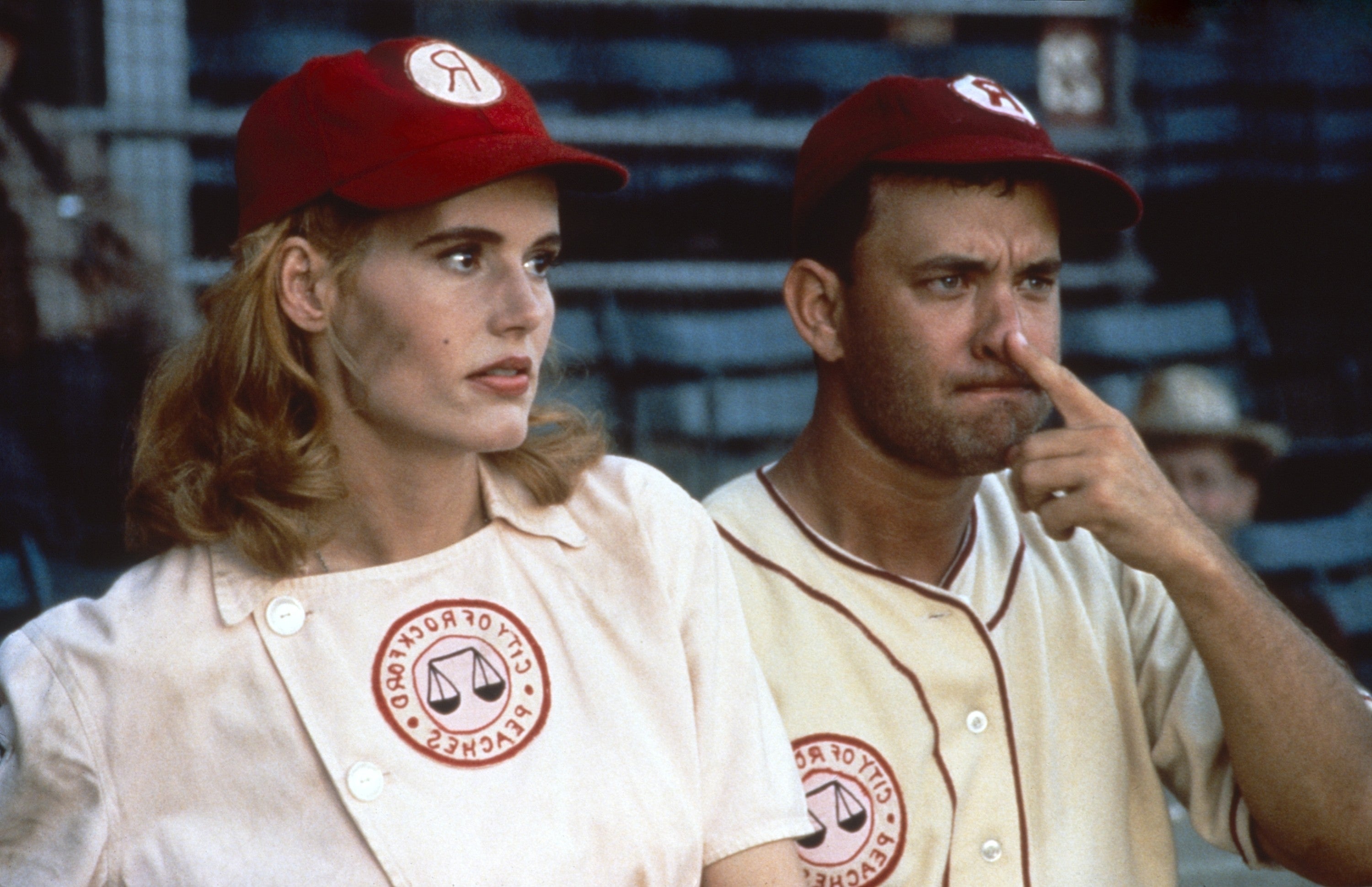 Two people in 1940s baseball uniforms, wearing caps, appear focused, suggesting an intense moment during a game