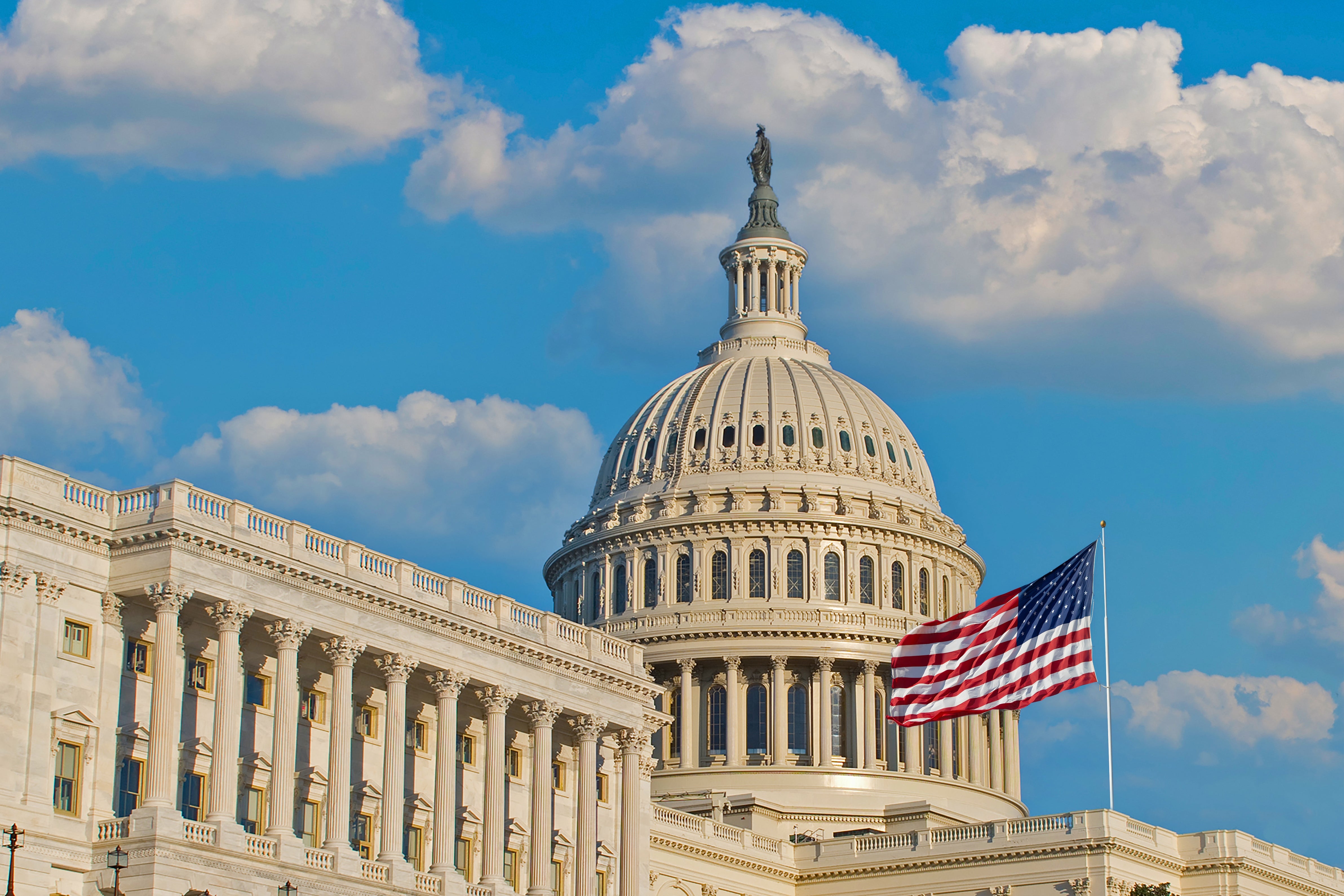 U.S. Capitol gathering  with an American emblem  successful  the foreground, nether  a wide   sky