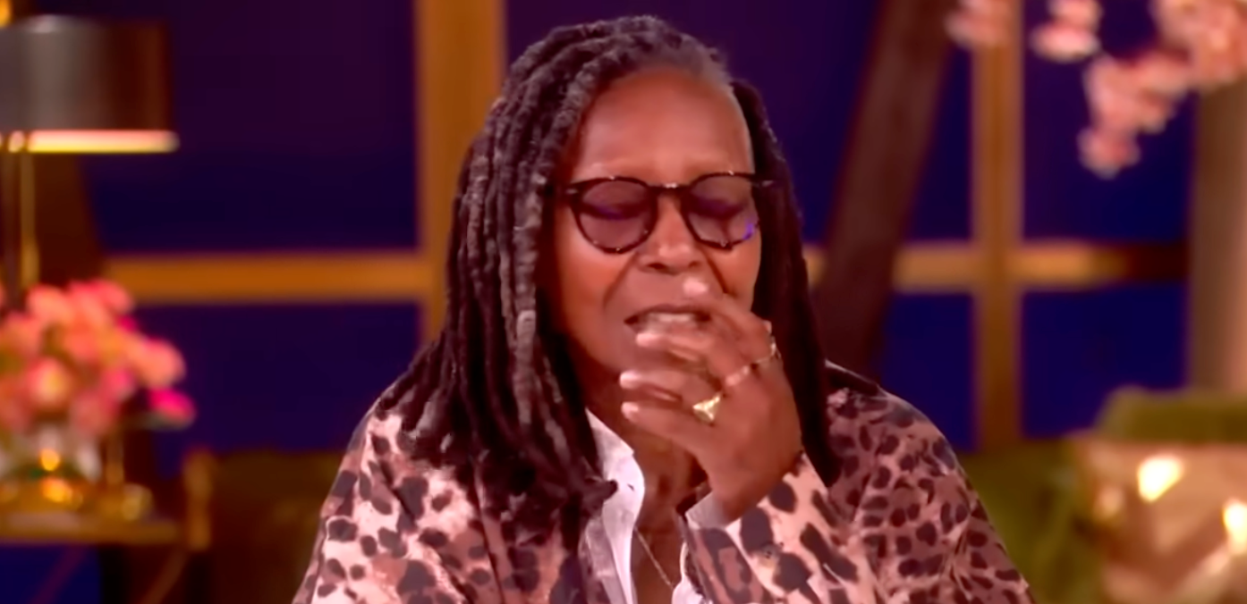 Person with dreadlocks and glasses speaking successful  an interview. They deterioration  a leopard people     overgarment   implicit    a achromatic  shirt, seated indoors with blurred background