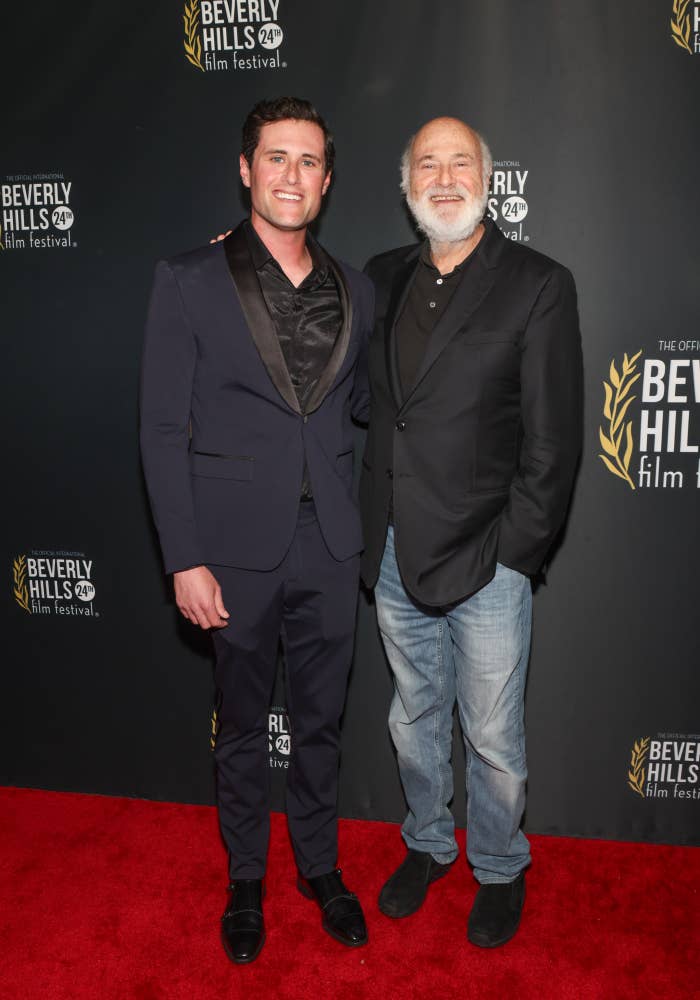 Two men connected  the Beverly Hills Film Festival reddish  carpet. One wears a ceremonial  suit, the different   a blazer with jeans, some  smiling for the camera