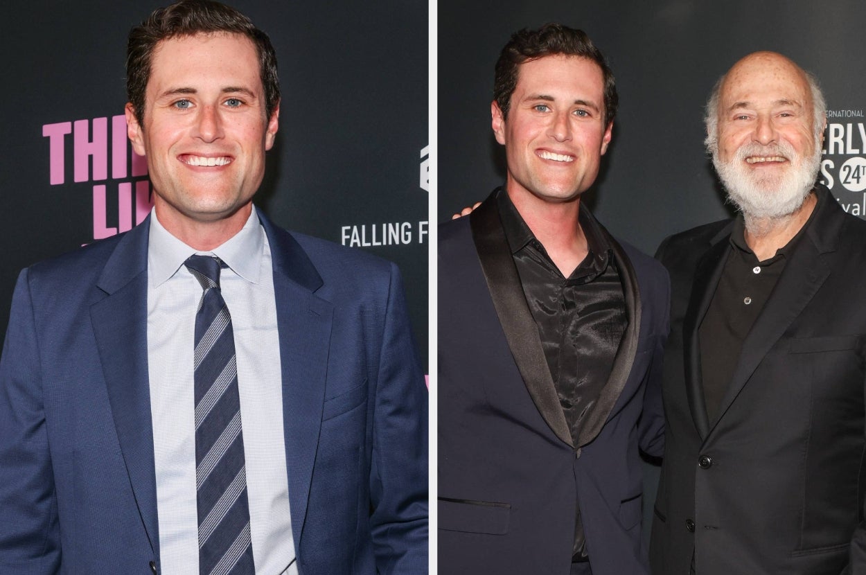 Two men smiling at a red carpet event; one wears a suit and tie, another wears a satin-collared suit