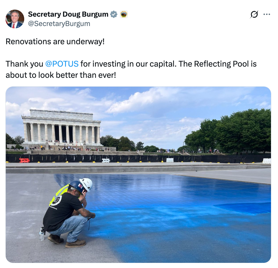 Worker paints pavement adjacent   the Lincoln Memorial, improving the Reflecting Pool area
