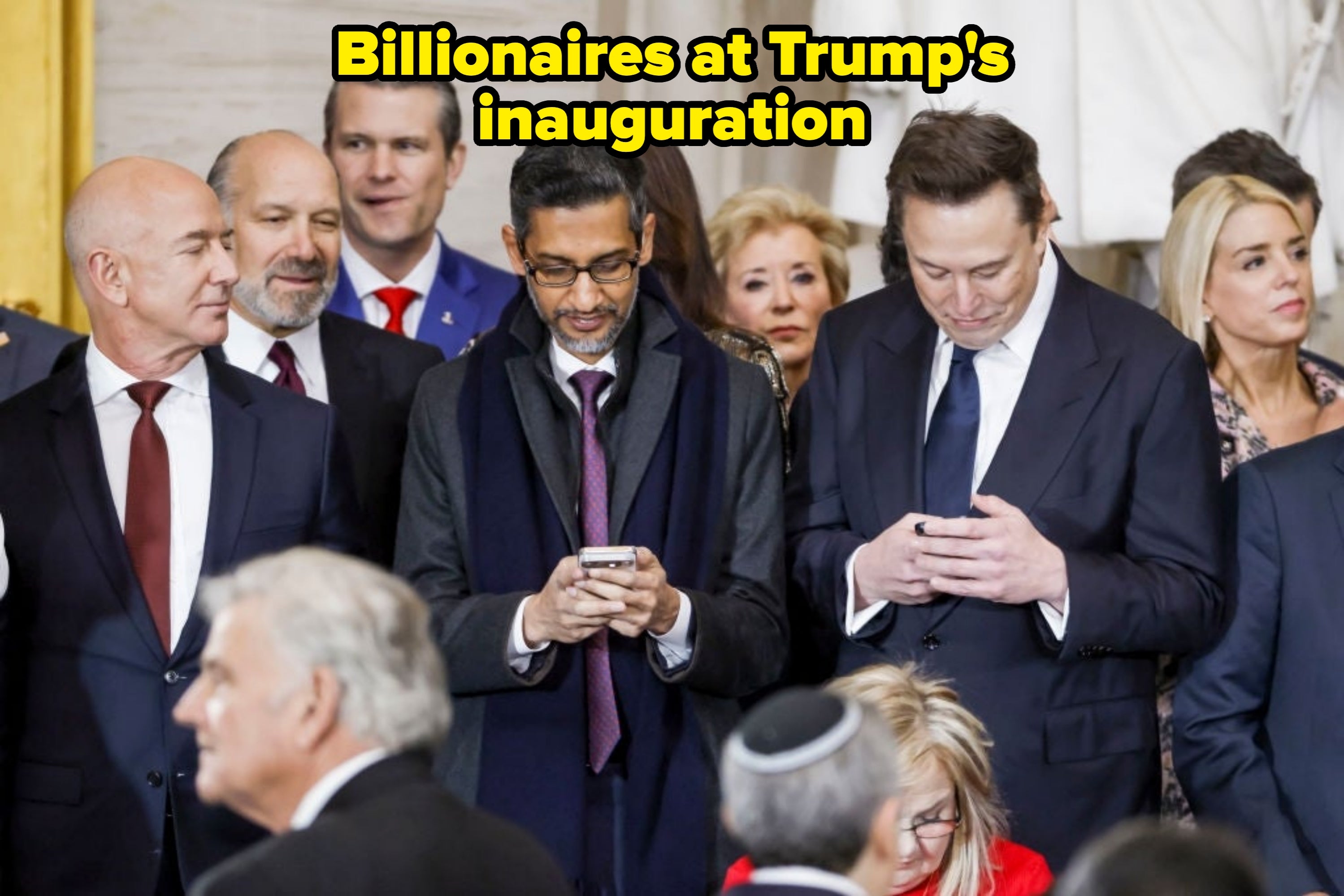 A radical  of concern  radical   successful  ceremonial  attire, looking astatine  their phones during a nationalist   event