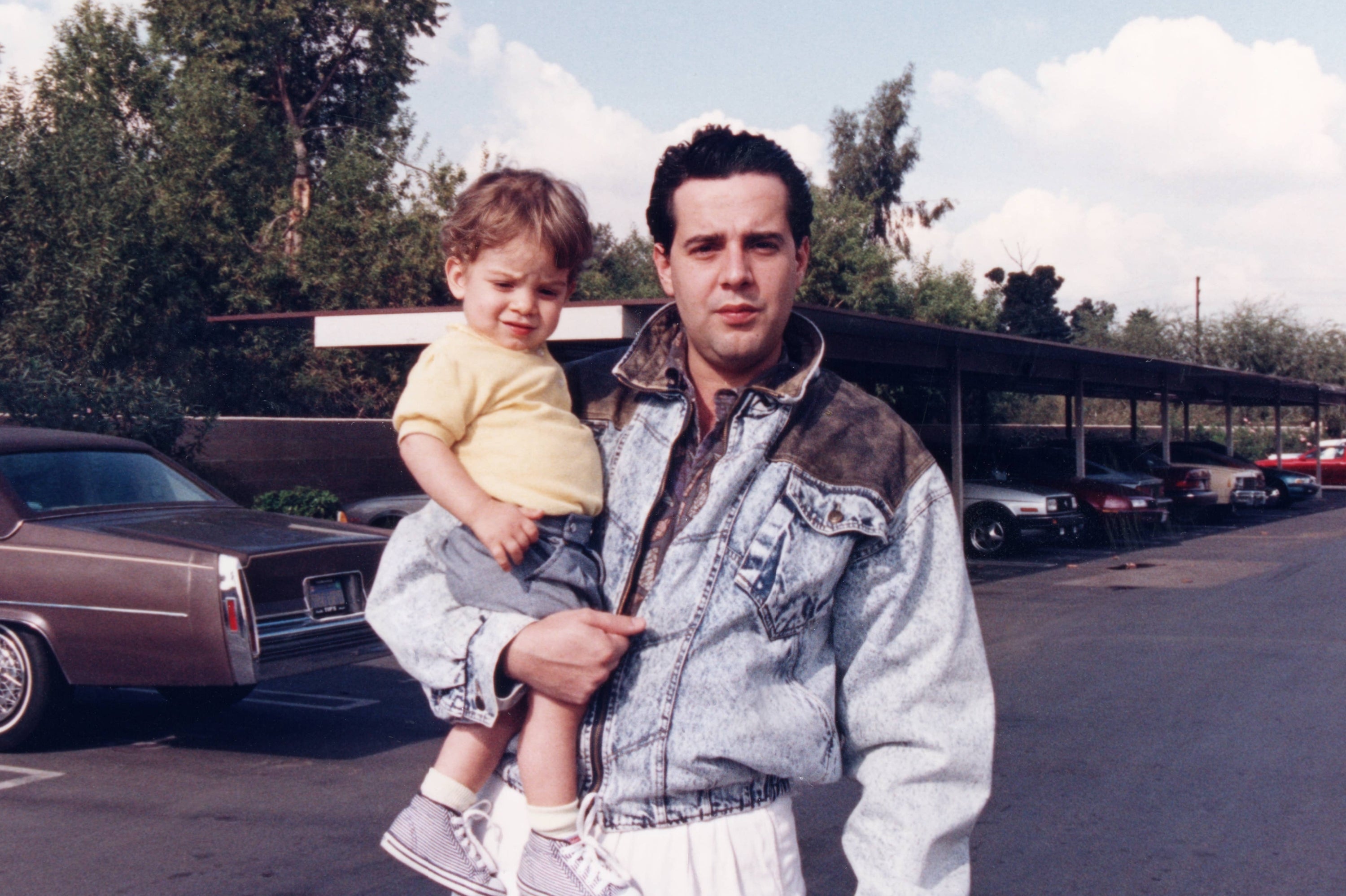 Two vintage photos: Left, man with child smiling; right, man in casual wear holding child, circled for emphasis