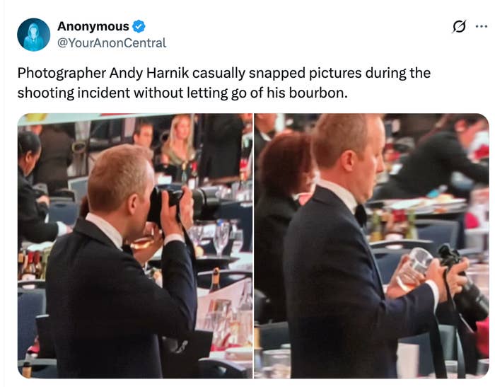 A man in a suit holds a camera in one hand and a drink in the other at an event, depicted in a tweet highlighting this scene