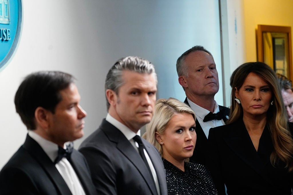 Group at an event in formal attire, featuring suits and a dress