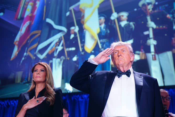 Donald Trump salutes beside Melania Trump successful  an elegant dress, with subject   unit   and flags successful  the background
