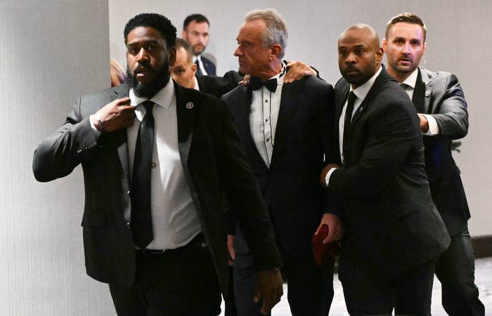 Group of suited information    unit   escort RFK Jr astatine  an event, ensuring his information   and navigating done  a crowd