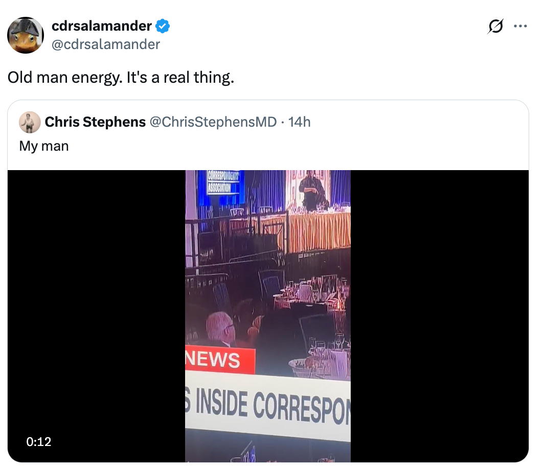 Video screenshot of news coverage featuring an older man with tables in a large event setting, captioned as “Old man energy. It's a real thing.”