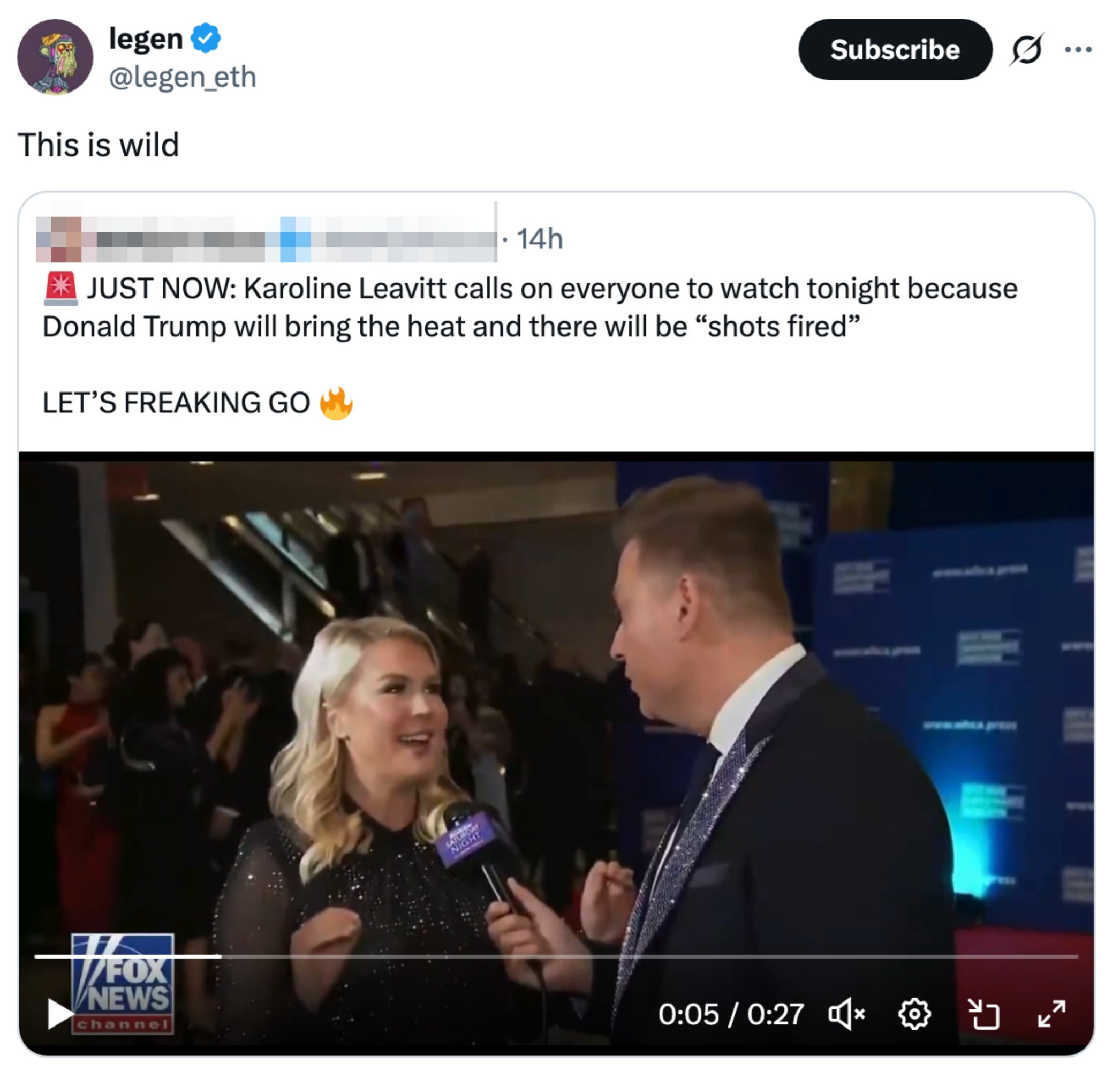 A pistillate   being interviewed connected  a reddish  carpet, wearing a ceremonial  dress, with a backdrop and microphone visible