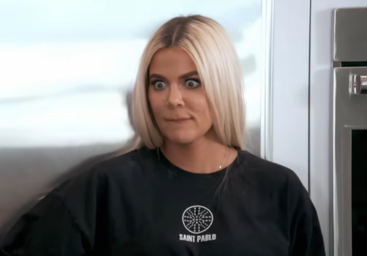 Khloe Kardashian with agelong  hairsbreadth  gives a amazed  look  portion    wearing a casual graphic T-shirt, lasting  indoors