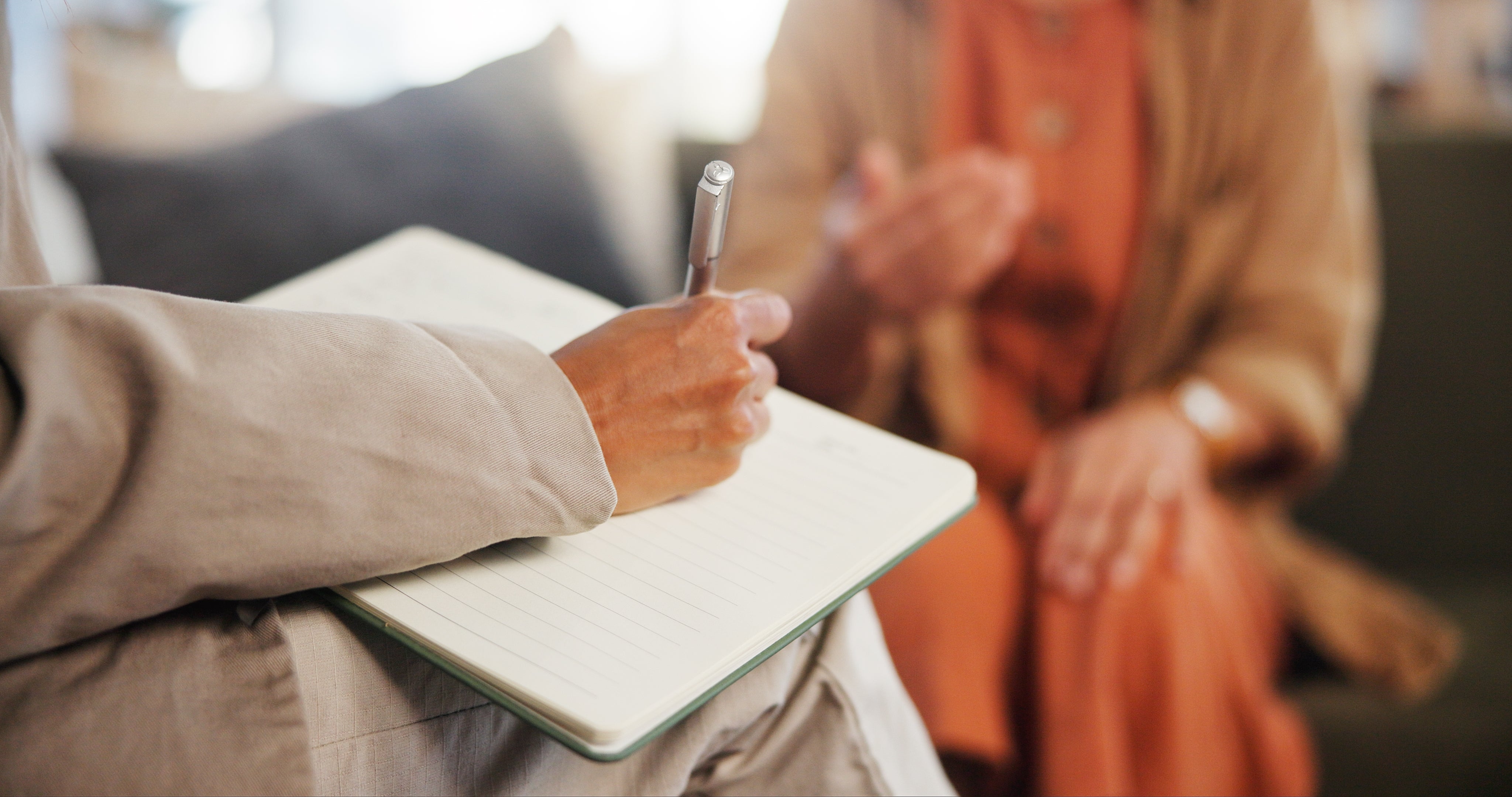 Person penning  successful  a notebook during a speech  with different  idiosyncratic   gesturing with their hands