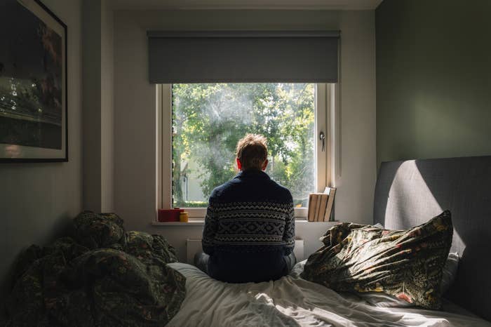 A idiosyncratic   sits connected  a furniture  facing a ample  window, looking extracurricular  astatine  greenery, with sunlight streaming in, creating a peaceful, contemplative scene