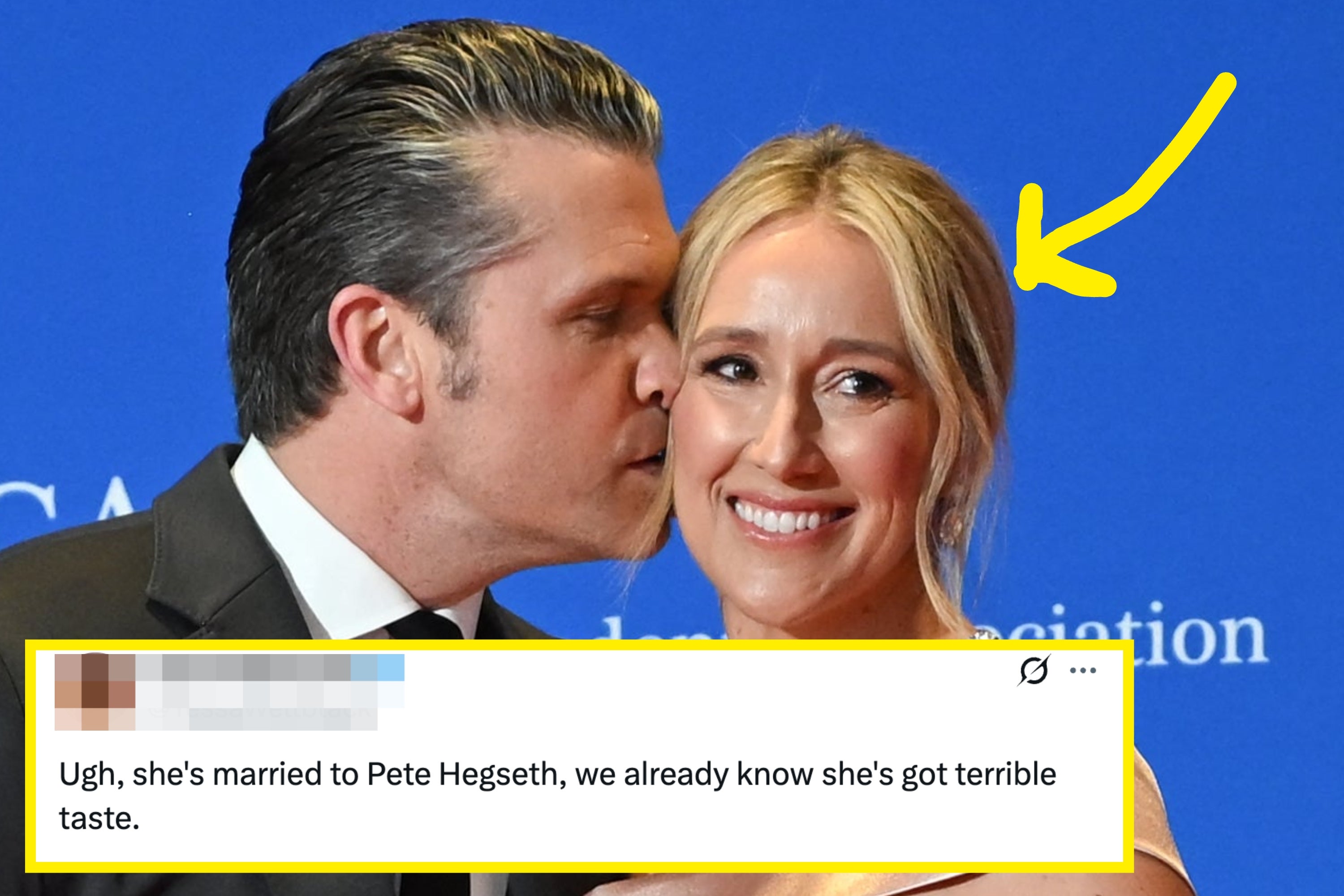 A couple poses at an event. The woman wears an elegant off-shoulder gown, and the man is in a classic suit. They stand before a backdrop with event text