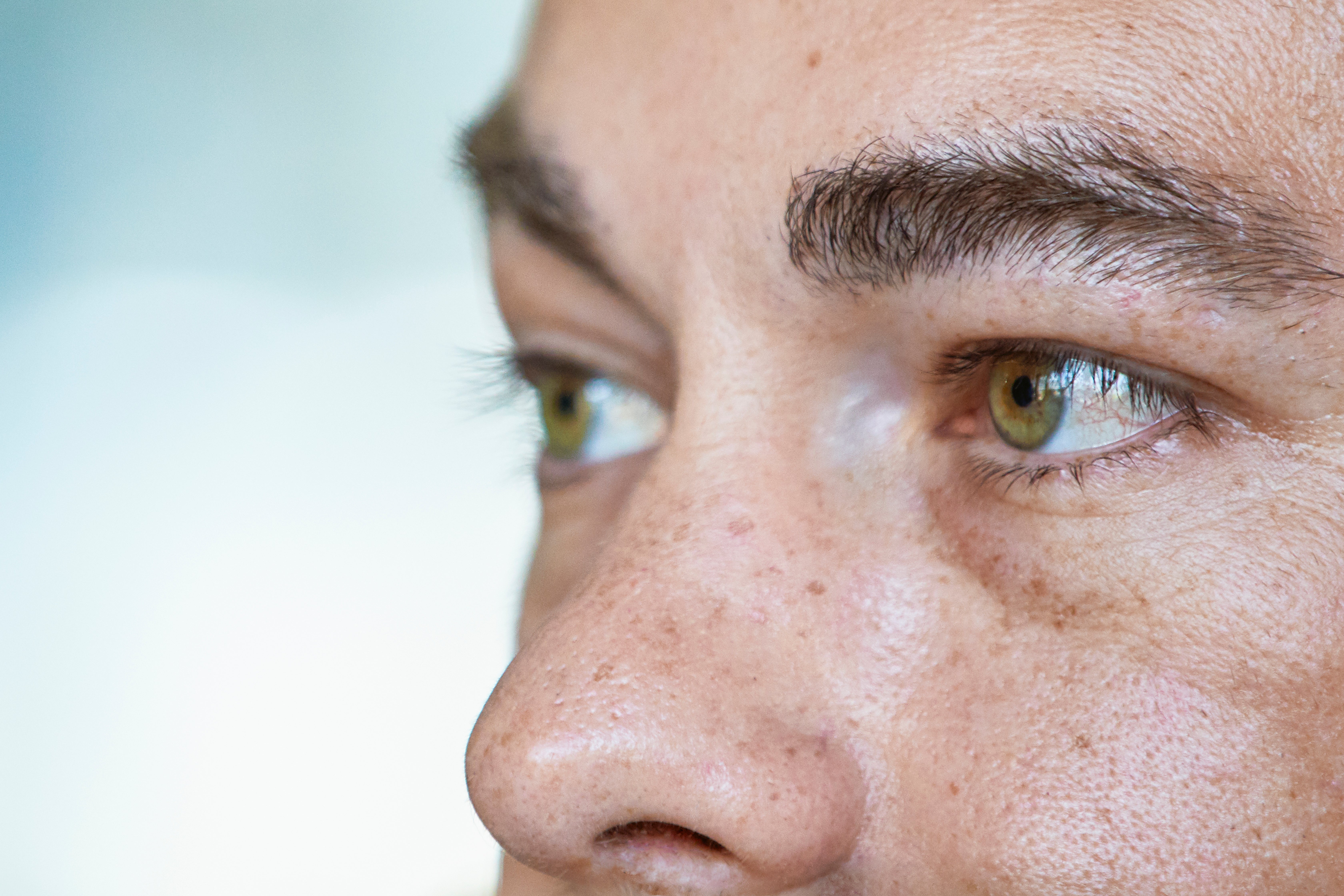 Close-up of a person's eyes and nose, focused connected  the gaze, with disposable   tegument  texture and eyelashes