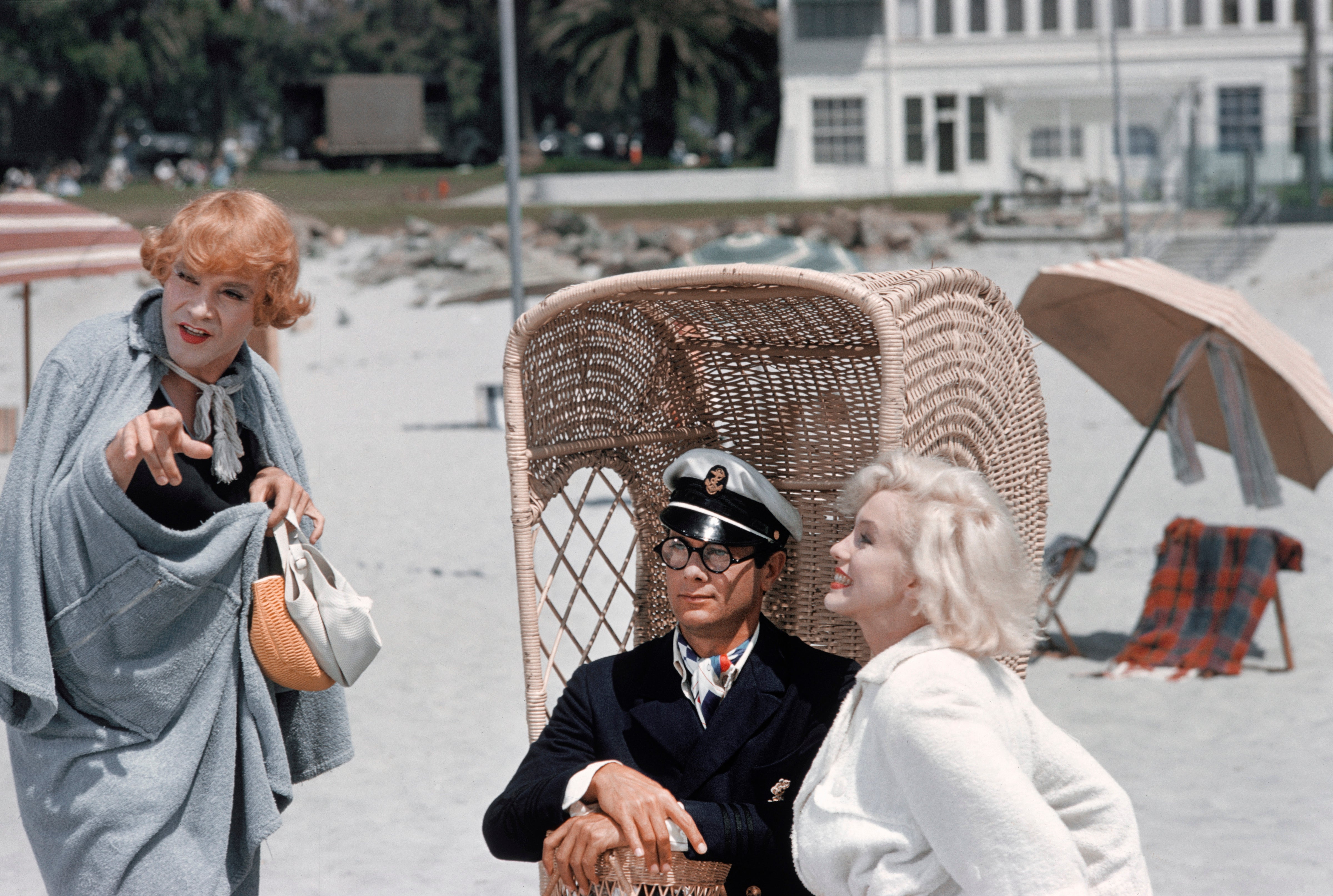 Three radical   connected  a sandy beach; 1  successful  a captain's outfit, 2  successful  vintage attire. The temper  is playful with a coastal backdrop