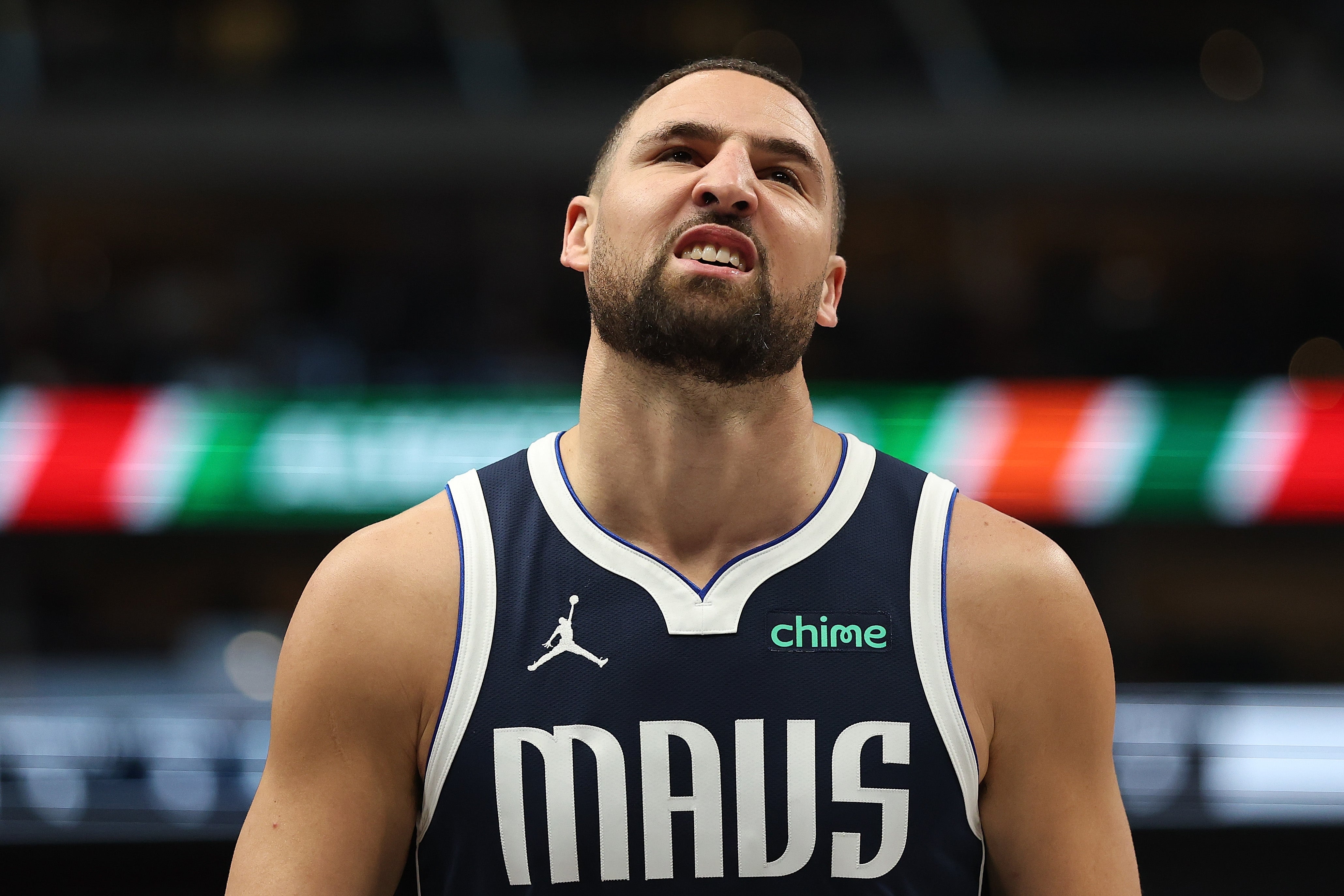 Basketball subordinate    successful  a Mavs jersey grimacing during a game