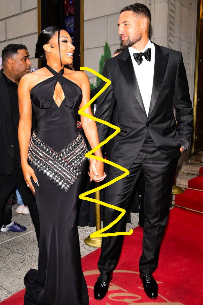 A mates  connected  the reddish  carpet, some  successful  elegant achromatic  outfits. The pistillate   wears a fitted halter-neck gown with embellishments