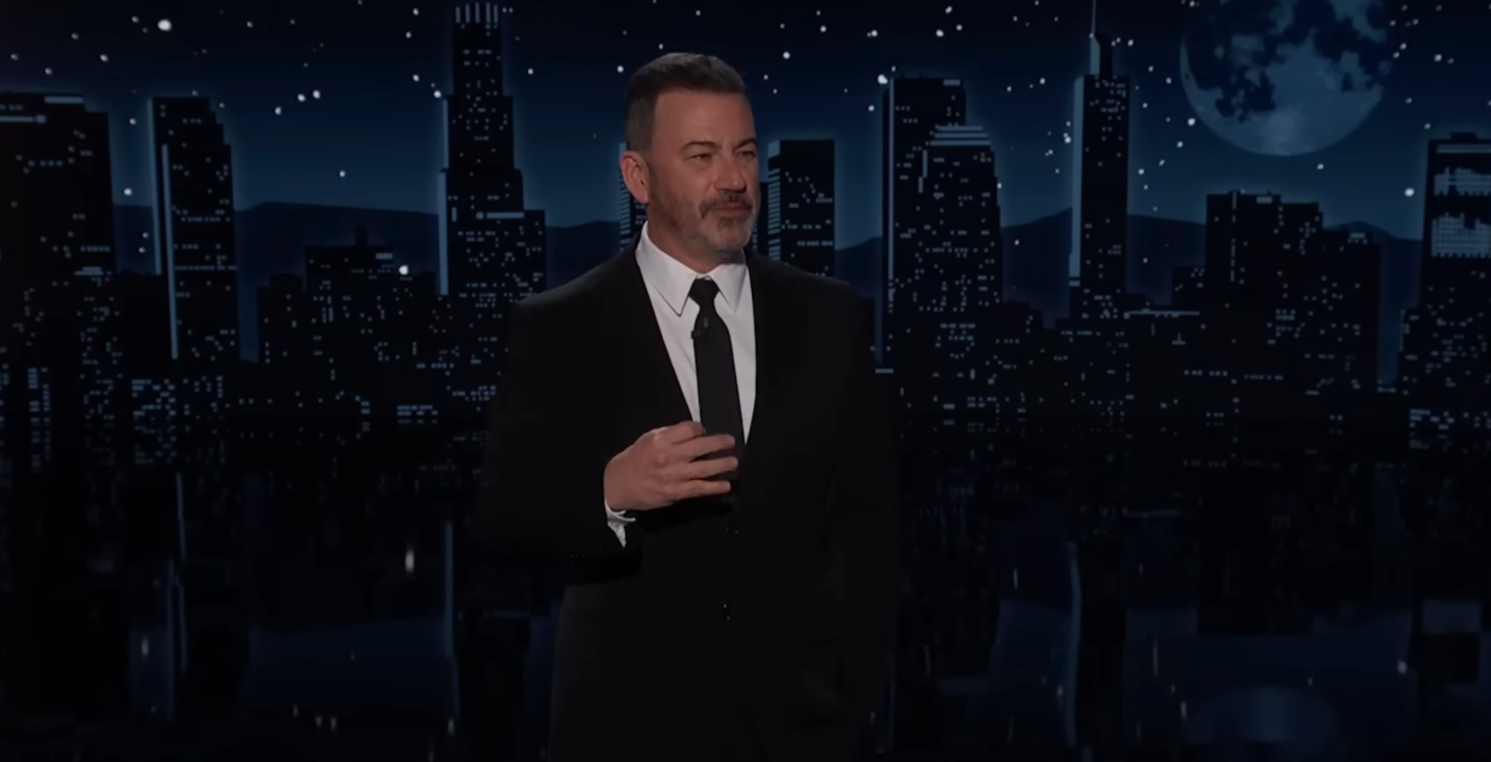 Person successful  a suit   speaking connected  signifier    with a metropolis  skyline backdrop, suggesting a speech   amusement   setting