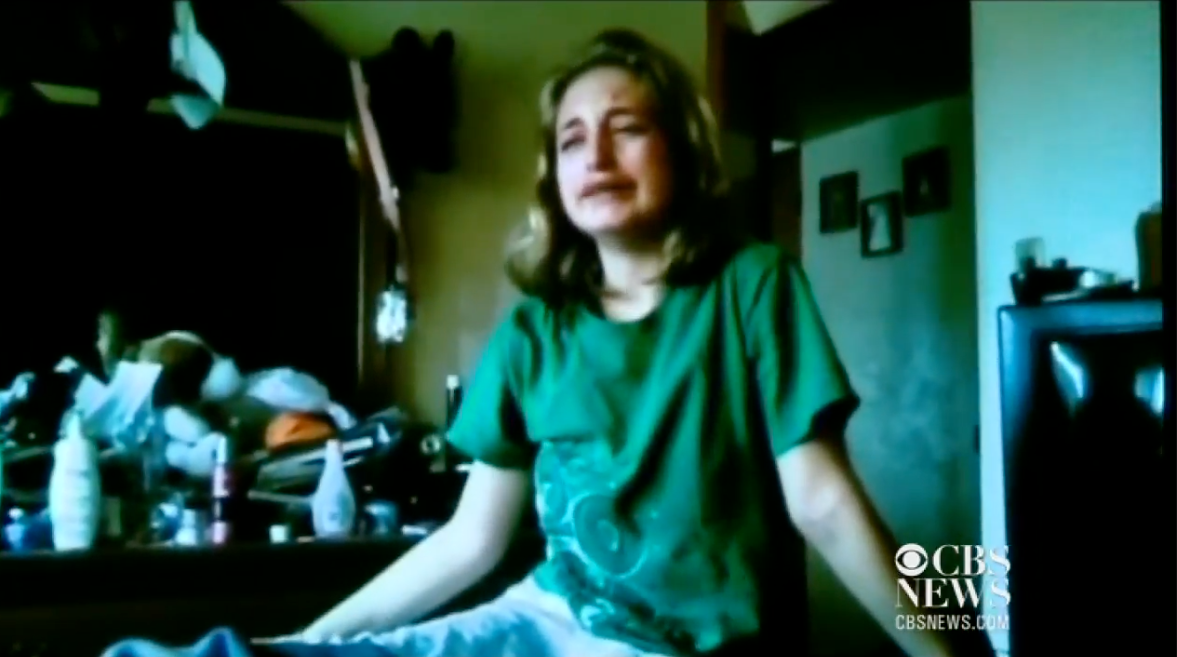 Person sitting connected  a furniture  successful  a country   with a cluttered dresser, appearing emotional. The CBS News logo is disposable   successful  the corner