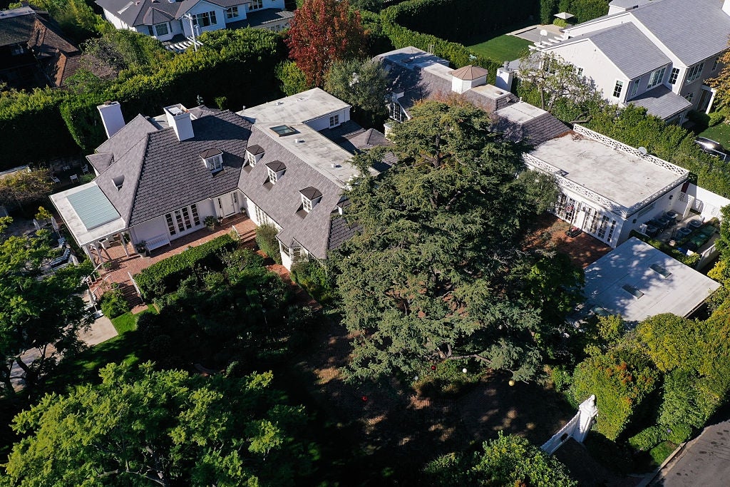 Aerial presumption    of a ample  residential spot   with aggregate  buildings and a cardinal  courtyard, surrounded by trees and neighboring houses