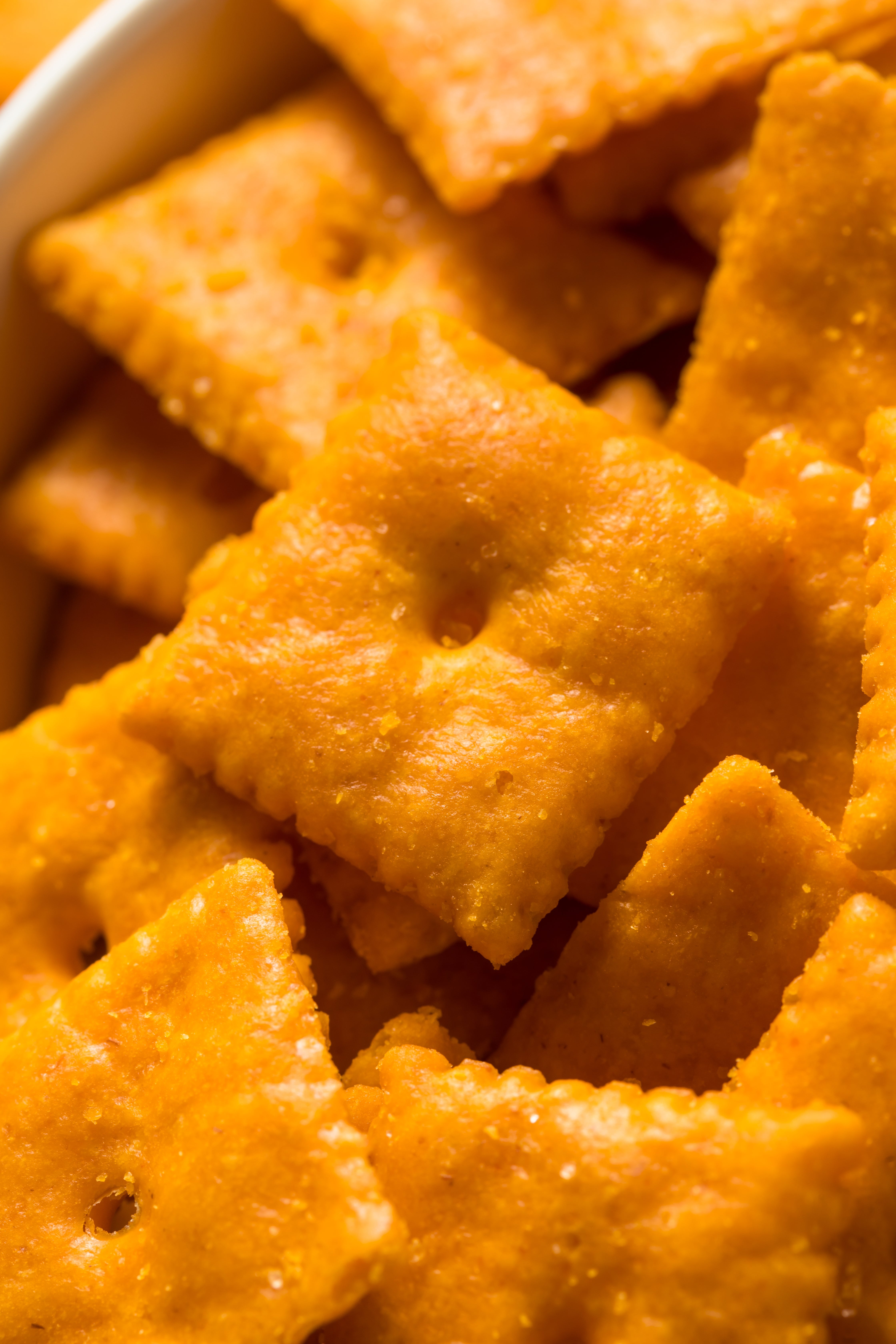 Close-up of cheese-flavored quadrate  crackers successful  a bowl. Ideal for a wellness  nonfiction  discussing snack choices oregon  nutritional content
