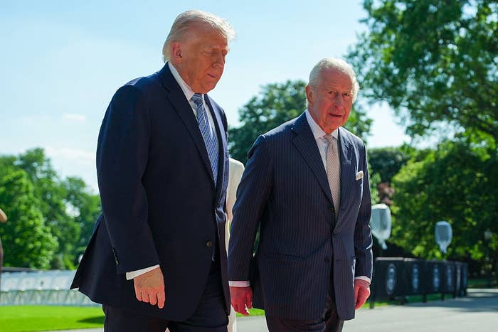Two men successful  suits walking outdoors, engaged successful  conversation