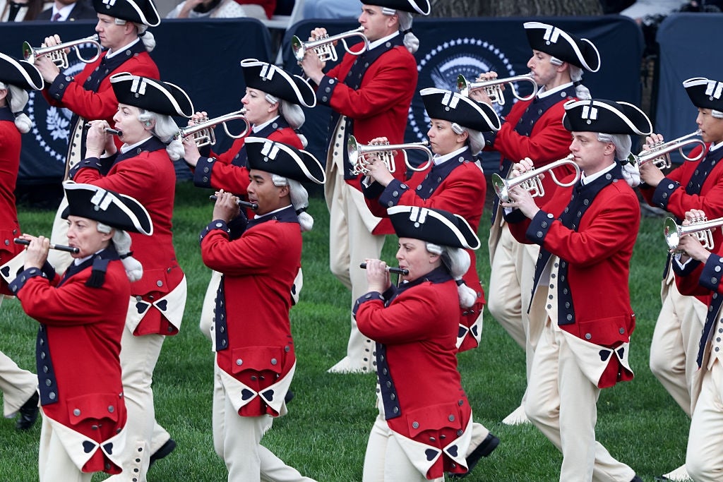 Marching set  successful  colonial-style uniforms playing instruments outdoors