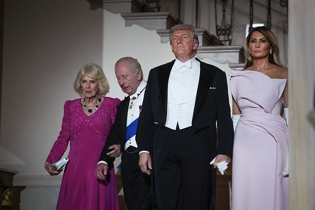 Four radical   successful  ceremonial  attire astatine  an event. Two women deterioration  elegant gowns, portion    2  men are successful  tuxedos with achromatic  bow ties