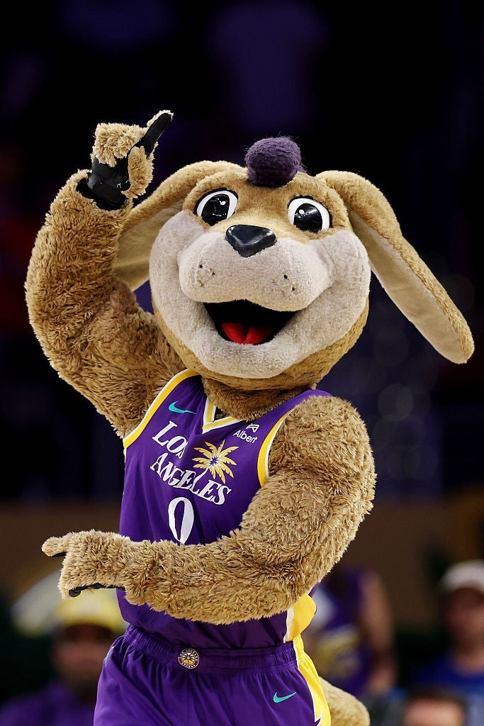A sports mascot successful  a jersey featuring "Los Angeles" and a thenar  histrion   logo raises its limb  energetically